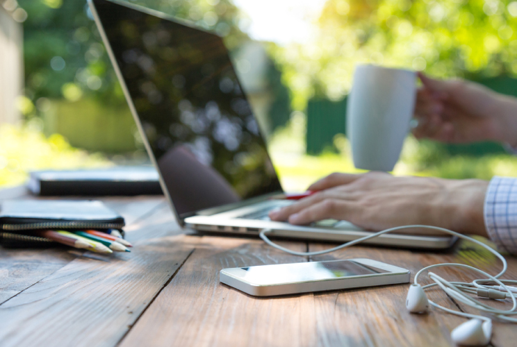 image of a man with a laptop and coffee cup for the mti blog